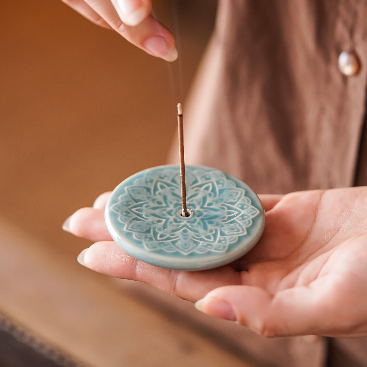 Celadon ceramic incense disc with an open lotus relief