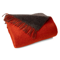 Reversible wool throw in orange and brown with fringed edges
