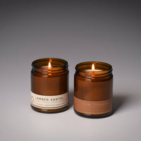 Two amber glass soy candles, Amber Santal and Smokin' Cowboy