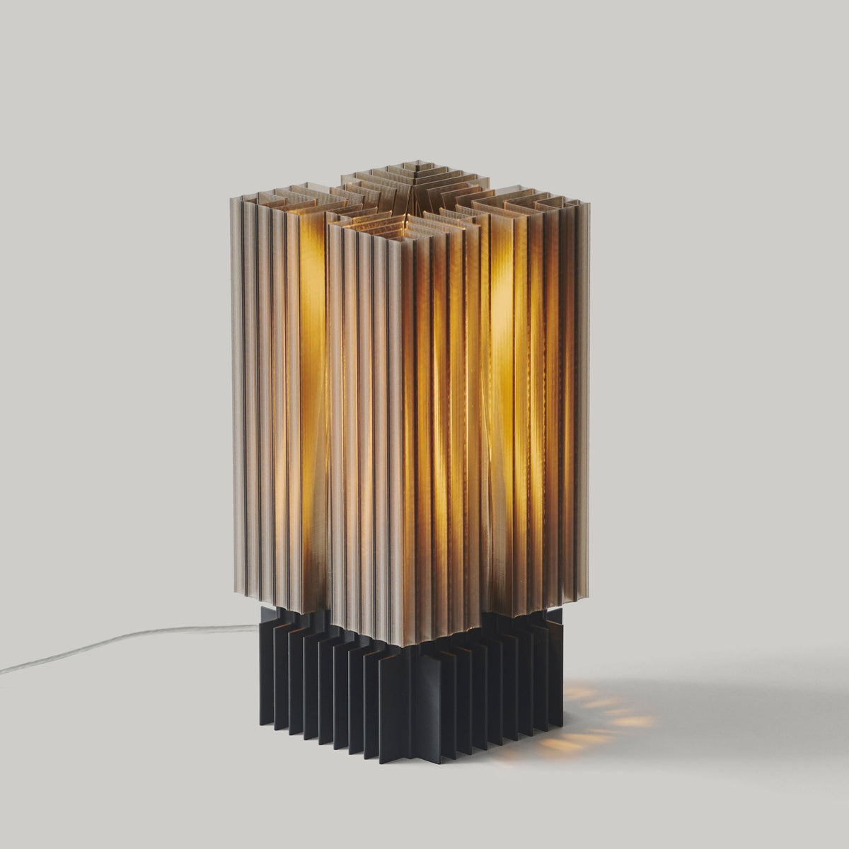Table lamp with a geometric, brutalist-inspired textured shade