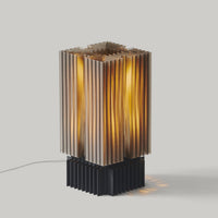 Table lamp with a geometric, brutalist-inspired textured shade