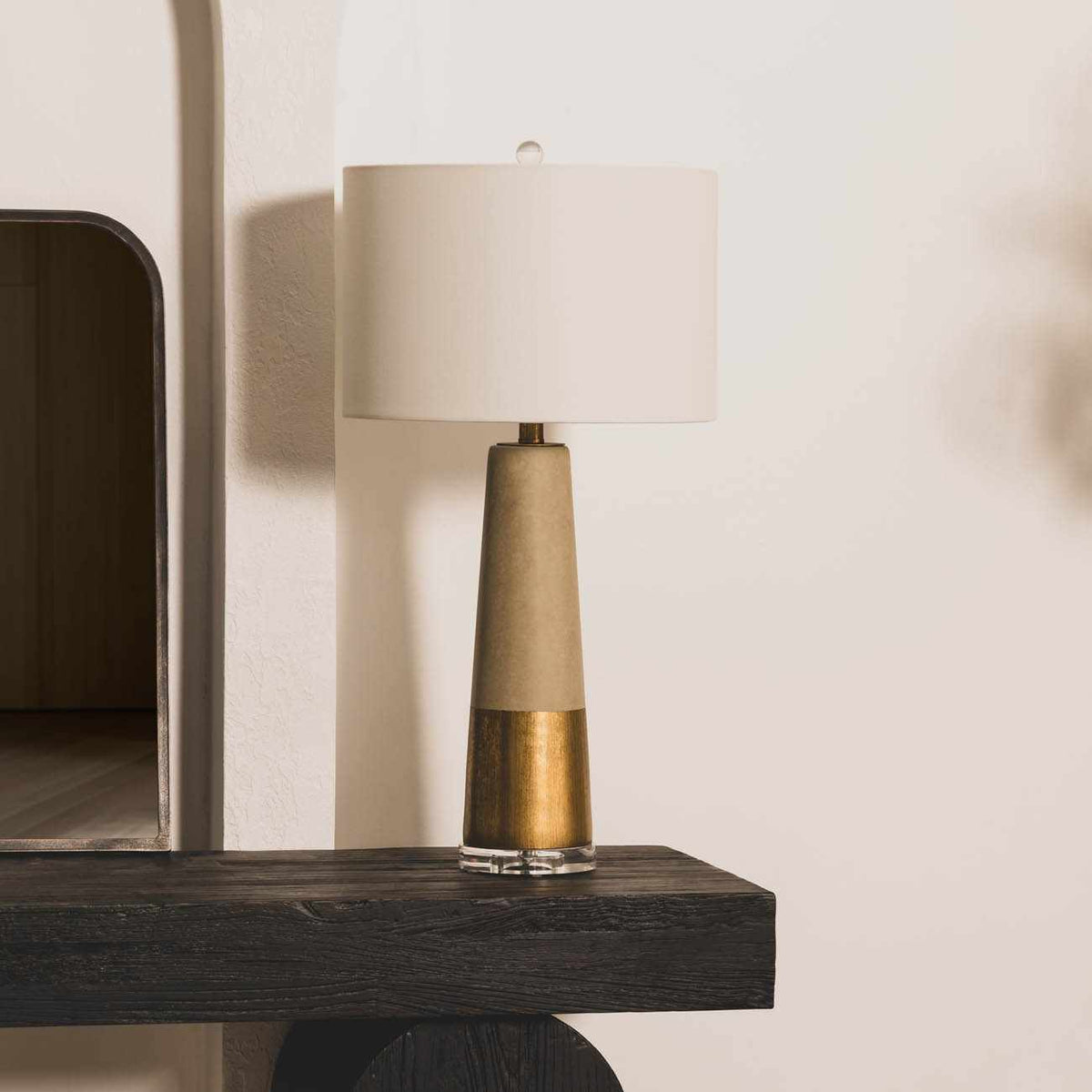 Gray cement table lamp on a clear crystal base with a cream linen shade