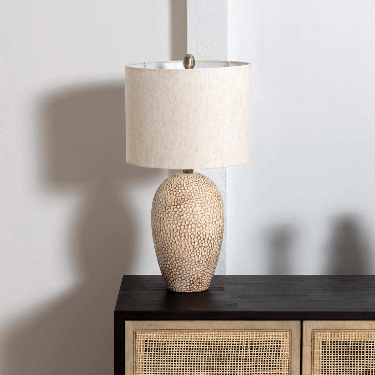 Textured beige ceramic table lamp with a beige linen shade