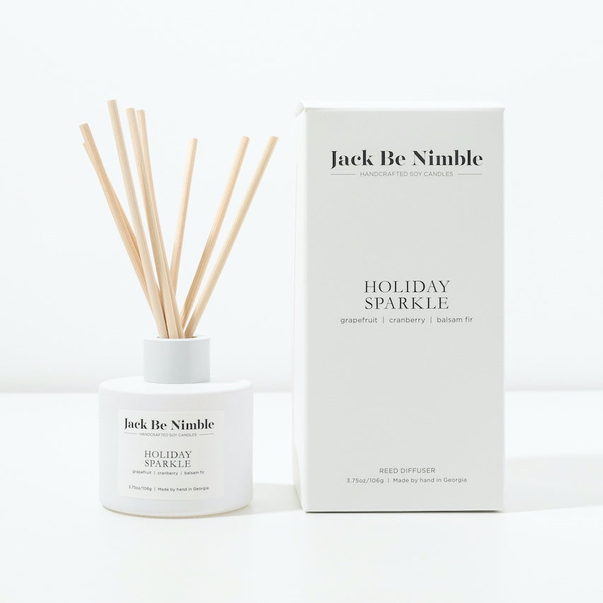 Holiday Sparkle reed diffuser in a matte white glass vessel