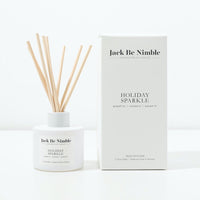 Holiday Sparkle reed diffuser in a matte white glass vessel