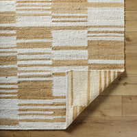Natural jute flatweave rug in ivory and tan stripe pattern.