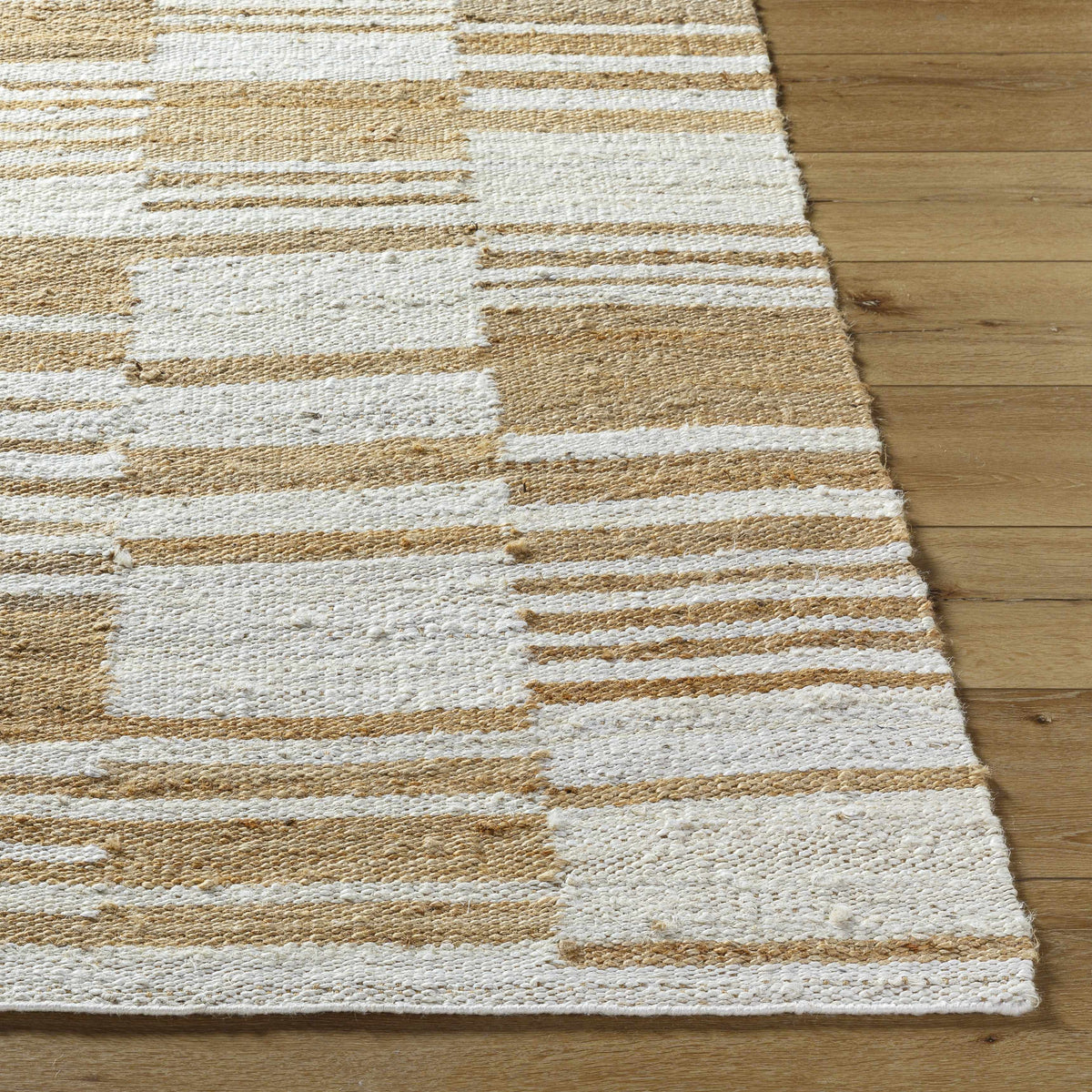 Natural jute flatweave rug in ivory and tan stripe pattern.
