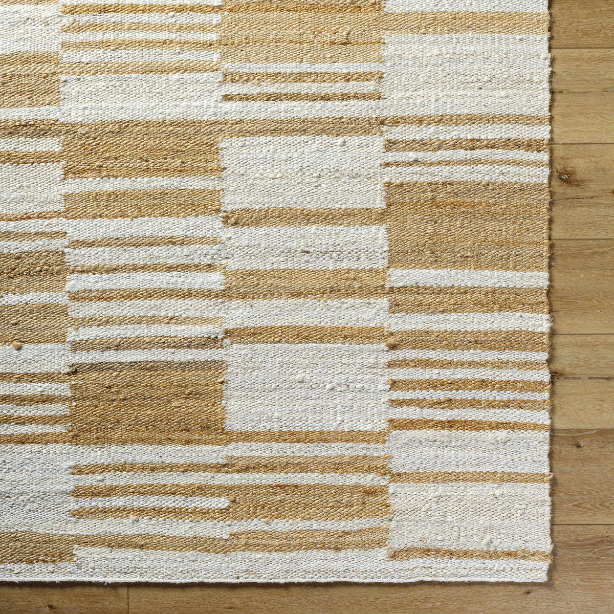 Natural jute flatweave rug in ivory and tan stripe pattern.