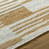 Natural jute flatweave rug in ivory and tan stripe pattern.