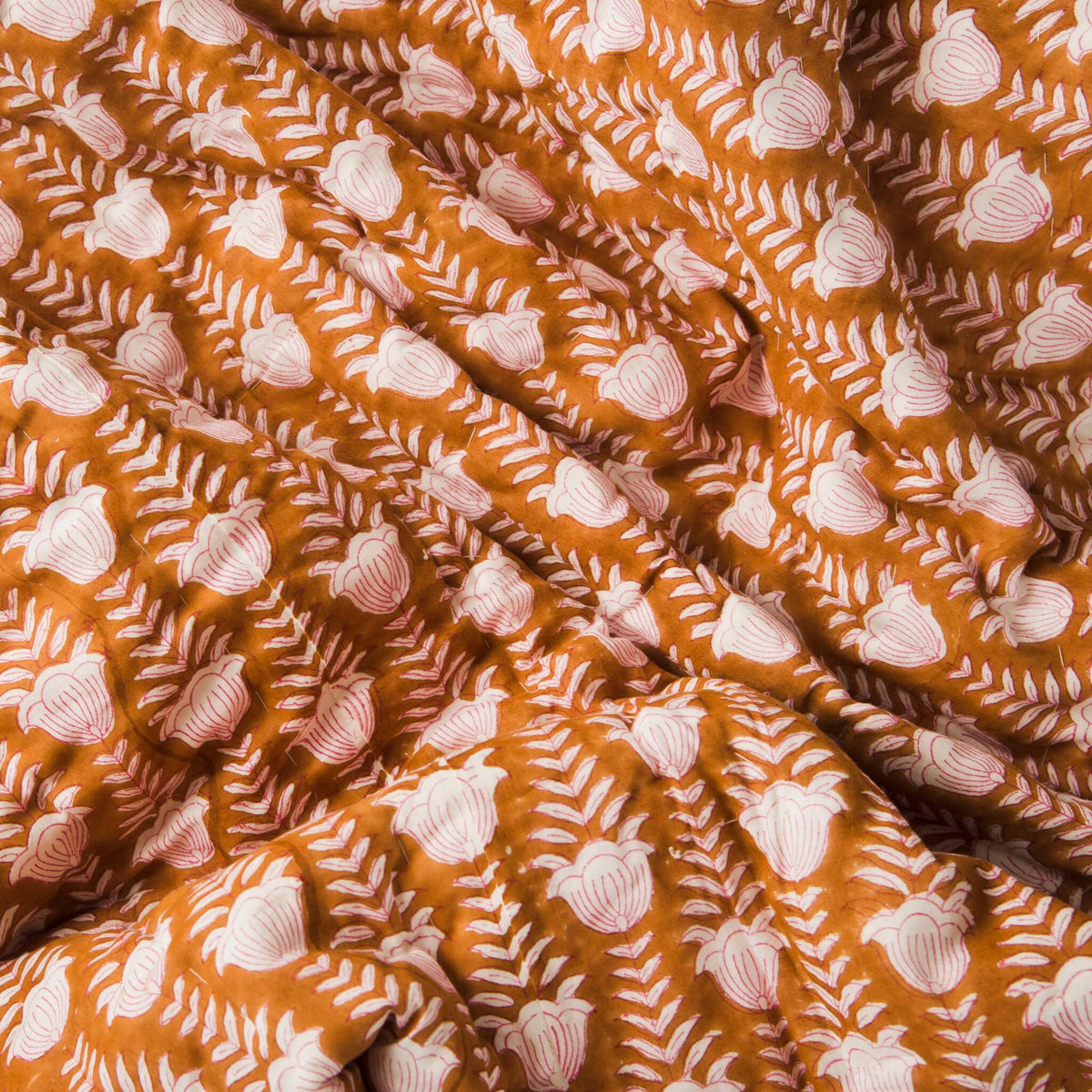 Reversible cotton throw with block-printed tulips on a golden background