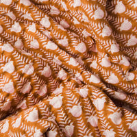 Reversible cotton throw with block-printed tulips on a golden background